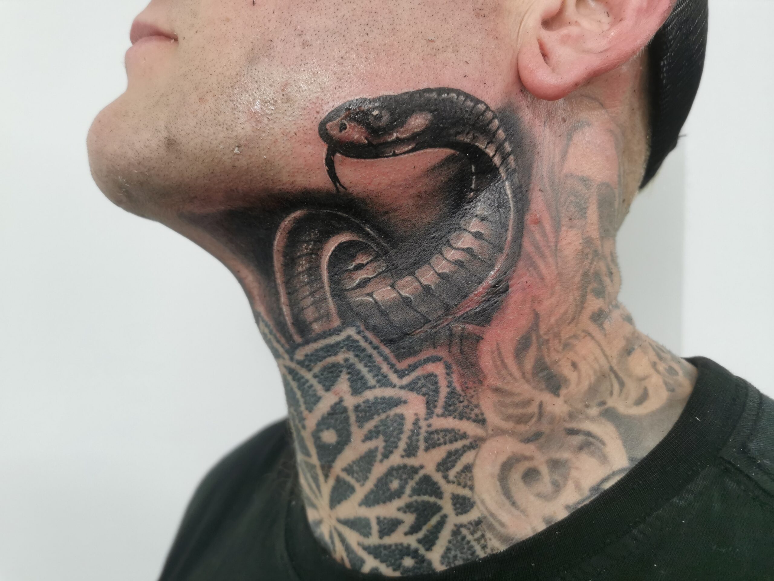 Serpent neck tattoo